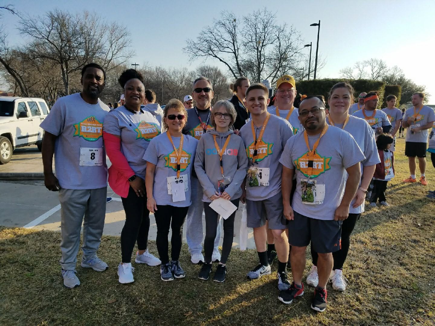 A group of people outdoors wearing matching event shirts.