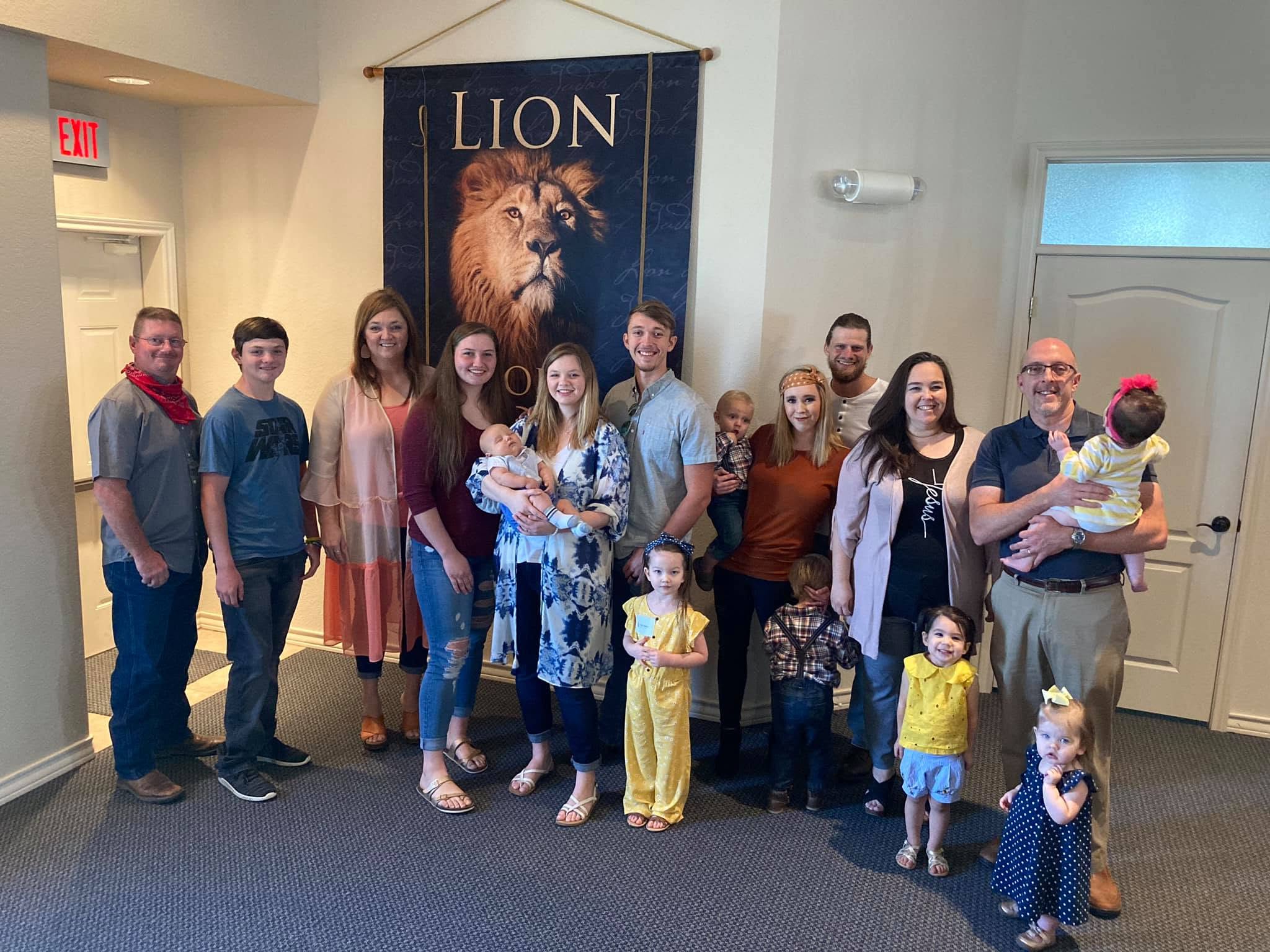 Adults and children gathered for a family group photo.